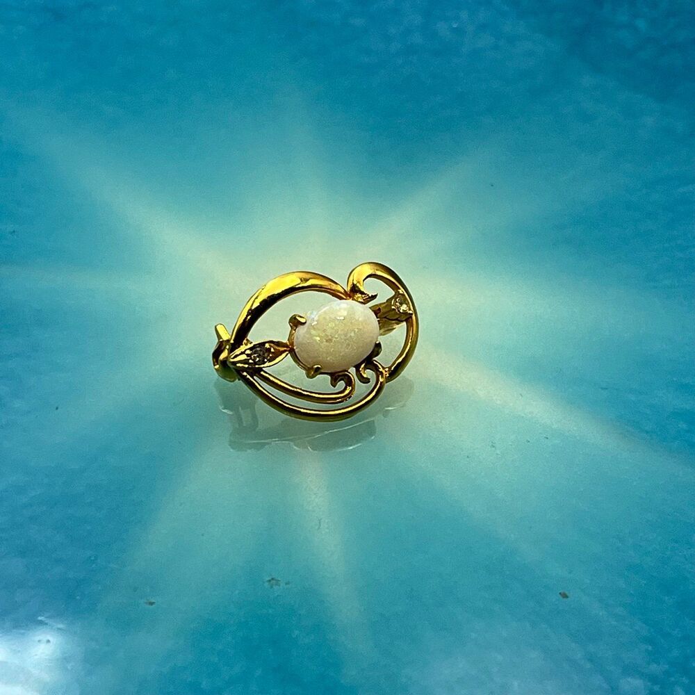Vintage small gold tone opal and cubic zirconia brooch